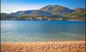 Słano, Chorwacja. Ustronne miejsce inaczej – spokojna zatoka, piaszczysta plaża i malownicze domki w oddali.