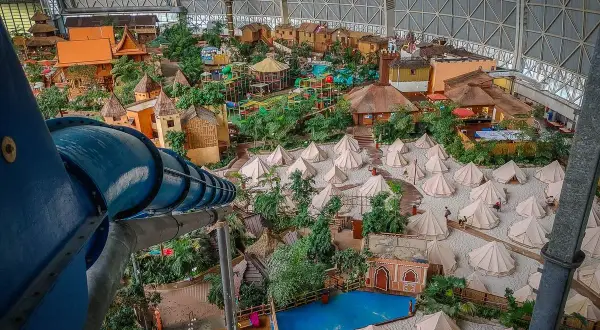 Wielki basen Tropical Island w Berlinie, z tropikalną wioską, zjeżdżalniami i namiotami na piasku.